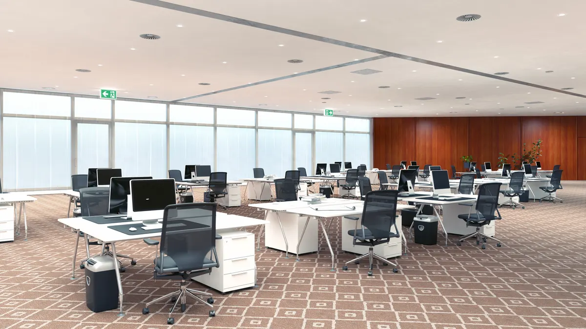 An open-plan office with patterned commercial carpet